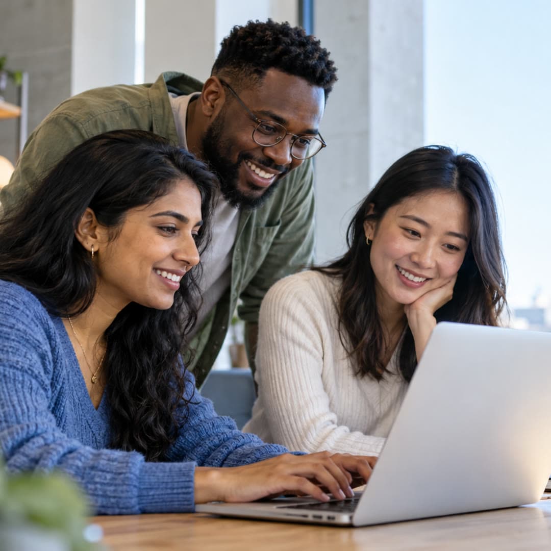 Three professionals reviewing a job application on a laptop